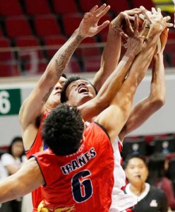 Kieth Agovida of Blackwater Elite struggles to blast through the defense of Jireh Ibanes and ReymondAlmazan of Rain or Shine during a PBA Philippine Cup game at the Mall of Asia Arena in Pasay City on Saturday. PHOTO BY CZEASAR DANCEL