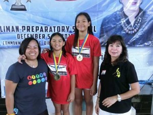 Record-breakers Immaculate Heart of Mary College-Paranaque’s Micaela Jasmine Mojdeh (center left) and University of the Philippines Integrated School’s Charize Juliana Esmero pose with Philippine Swimming League NCR Regional Director Joan Mojdeh (left) and PSL Secretary General Maria Susan Benasa. CONTRIBUTED PHOTO