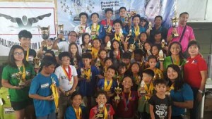 Philippine Swimming League (PSL) President Susan Papa and Secretary General Maria Susan Benasa award the trophies to the Most Outstanding Swimmers in the 88thPSL National Series - Inter-School/Inter-Club Motivational Yearender Swimming Meet. CONTRIBUTED PHOTO