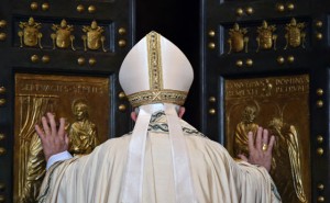 RARE MOMENT Pope Emeritus Benedict XVI (right) is helped by the prefect of the papal household Georg Gaenswein to pass the ‘Holy Door’ as Pope Francis looks on, during the ceremony marking the start of the Jubilee Year of Mercy. AFP PHOTO 