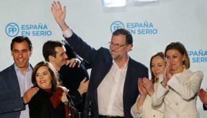 SPAIN FACING COALITION GOVERNMENT  Spanish Prime Minister and Popular Party (PP) leader Mariano Rajoy (3rd right) waves after delivering a speech next to his wife Elvira Fernandez (R), Vice President of the Spanish government Soraya Saenz de Santamaria (2nd left), PP Secretary General and candidate Maria Dolores de Cospedal (R) and other party members at PP’s headquarters after the results of Spain’s general election in Madrid on December 20. Spain’s ruling conservative Popular Party won the most seats in parliament in the general election but lost its absolute majority, partial results showed with over 80 percent of votes counted. AFP PHOTO