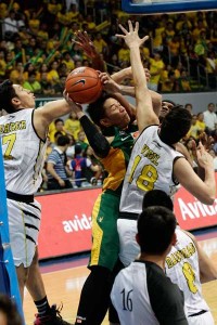 Roger Pogoy (No.16) of Far Eastern University drives against the wall of defense of University of Sto Tomas players during Game One of the UAAP men’s basketball finals at the Mall of Asia Arena on Friday. PHOTO BY CZEASAR DANCEL