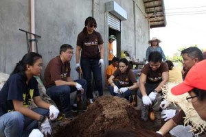 During their visit to the Mangarita Organic Farm in Capas, Tarlac, Tim Gohoc, Managing Director of UPS Philippines (2nd from left), and UPS Philippines employees prepare bags of sawdust where mushrooms will be grown