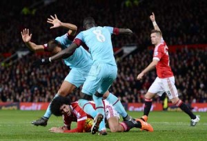 Manchester United’s Belgian midfielder Marouane Fellaini (center) falls in the penalty area by West Ham United’s Senegalese midfielder Cheikhou Kouyate during the English Premier League football match between Manchester United and West Ham United at Old Trafford in Manchester, north west England, on Sunday. AFP PHOTO