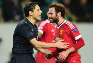 Serbian referee Milorad Mazic speaks to Manchester United’s Spanish midfielder Juan Mata during the UEFA Champions League Group B second-leg football match VfL Wolfsburg vs Manchester United in Wolfsburg, central Germany. AFP PHOTO