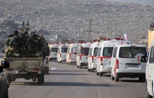 OUT OF HARM’S WAY  A convoy of ambulances transporting wounded civilians and rebels from the Syrian villages of Fuaa and Kafraya, the last two regime-held villages in Syria’s northwest Idlib province, is guarded by rebel fighters as it heads towards a border crossing with Turkey during an operation as part of a UN-backed truce on December 28. AFP PHOTO