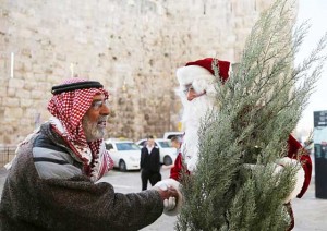 A Palestinian Christian dressed as Santa Claus greets a Palestinian muslim in Jerusalem’s old city on dec. 21, as Christians worldwide prepare to celebrate christmas. AFP Photo