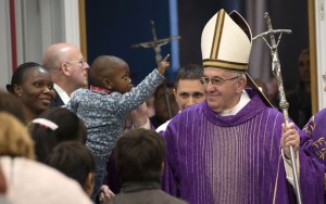  A boy gets amazed with the miter worn by Pope Francis after a ceremony for the opening of a ‘Holy Door’ at Rome’s Caritas (Charity) near the central railway station of Termini as part the Jubilee year of Mercy in Rome. In Catholic tradition, the opening of ‘Holy Doors’ in Rome symbolizes an invitation from the Church to believers to enter into a renewed relationship with God. AFP Photo / OSSERVATORE ROMANO