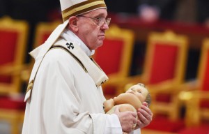 COME LET US ADORE HIM Pope Francis carries the statue of baby Jesus during a Mass on Christmas Eve marking the birth of Jesus Christ at Saint Peter’s basilica in the Vatican. AFP PHOTO 