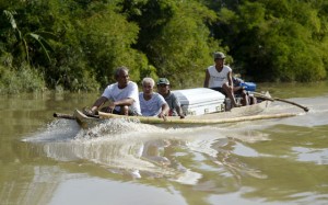 FINAL JOURNEY Residents transport a coffin over a flooded portion of Calumpit, Bulacan, one of the areas that remain submerged on Christmas Day. AFP PHOTO 