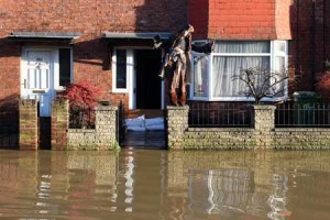 AHOY THERE A resident dressed as the character Captain Jack Sparrow from Pirates of the Caribbean film series stands outside his flooded house after the adjacent River Foss burst it’s banks in York, northern England, on December 27. AFP PHOTO