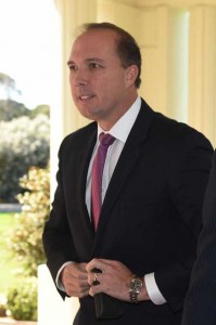 This photo taken on September 21, 2015 shows Australian Immigration Minister Peter Dutton arriving at Parliament House in Canberra. Dutton has apologized to a journalist for mistakenly sending her a message calling her a “mad witch.” AFP PHOTO