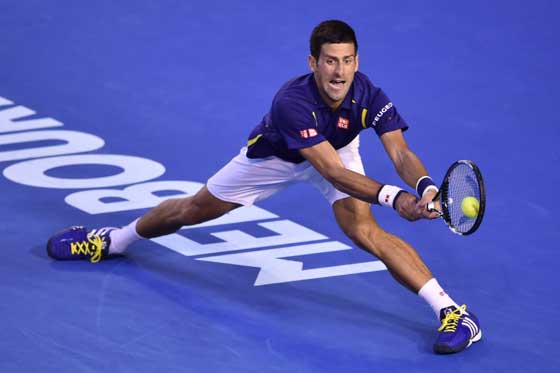 Serbia’s Novak Djokovichits a return during hismen’s singles semifinalsmatch against Switzerland’sRoger Federer on day elevenof the 2016 Australian Opentennis tournament inMelbourne on Thursday.AFP PHOTO