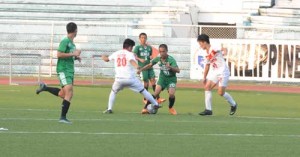 College of Saint Benilde booter John Michael Barot battles for the ball against San Beda College players in a National Collegiate Athletic Association football game at the Rizal Memorial Football Stadium on Tuesday. PHOTO BY JAELLE NEVIN REYES