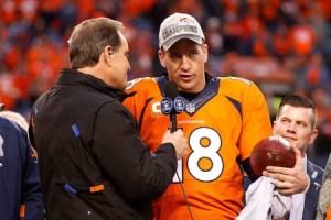 Peyton Manning, No.18, of the Denver Broncos holds the Lamar Hunt Trophy while speaking to CBS TV personality Jim Nantz after the Broncos defeated the New England Patriots in the AFC Championship game at Sports Authority Field at Mile High on January 24, 2016 in Denver, Colorado. AFP PHOTO