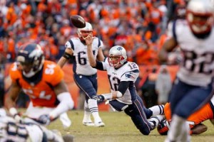 Tom Brady No.12 of the New England Patriots falls while passing in the second half against the Denver Broncos in the AFC Championship game at Sports Authority Field at Mile High on Monday in Denver, Colorado. AFP PHOTO