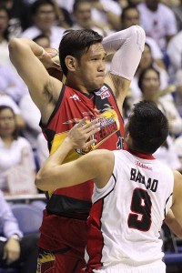 Junmar Fajardo of San Miguel Beer prepares to pass a ball through the defense of Nonoy Baclao of Alaska in Game 5 of the best-of-seven finals of the PBA Philippine Cup at Smart Araneta Coliseum in Quezon City on Wednesday. PHOTO BY CZEASAR DANCE