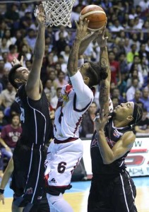 Calvin Abueva of Alaska blocks a shot of Chris Ross of San Miguel Beer in Game 6 of the best-of-seven finals of the PBA Philippine Cup at the Smart Araneta Coliseum in Quezon City on Friday. PHOTO BY CZEASAR DANCEL