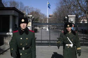 Paramilitary guards stand in front of the gates of Sweden’s embassy in Beijing on January 13, 2016. A Swedish man working for a human rights group in China has been detained on suspicion of endangering state security, his colleague said on January 12, as Beijing steps up controls on civil society. AFP PHOTO