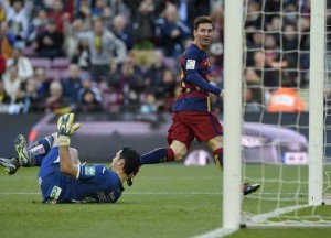 Barcelona’s Argentinian forward Lionel Messi (right) scores a goal during the Spanish league football match FC Barcelona vs Granada CF at the Camp Nou stadium in Barcelona. AFP PHOTO