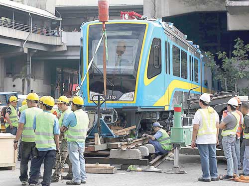 Workers set up a new Metro Rail Transit 3 coach at the MRT 3 Edsa station. The Department of Transportation and Communications said more new MRT 3 coaches will be delivered within the year to ease the shortage of coaches that has plagued rail riders for years. PHOTO BY RUSSEL L. PALMA