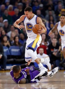 Stephen Curry No. 30 of the Golden State Warriors jumps over Ben McLemore No. 23 of the Sacramento Kings while dribbling at Oracle Arena in Oakland, California. AFP FILE PHOTO 