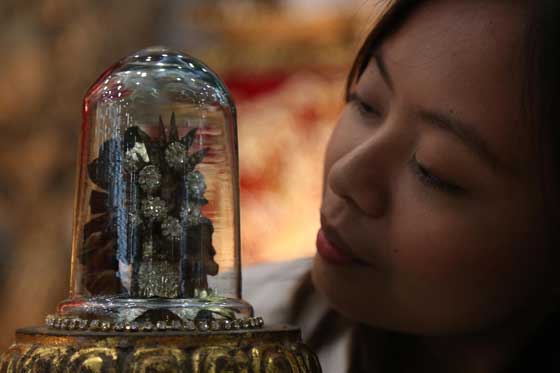 Angelina Dela Merced shows on Sunday a small statue of the Santo Nino that is part of the Santo Nino Exhibit in Baliwag, Bulacan. PHOTO BY RUSSELL PALMA