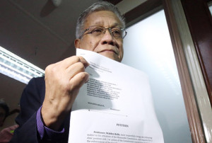 FOLLOW THE LAW Former congressman Walden Bello holds a copy of the petition he filed at the Commission on Elections. PHOTO BY DJ DIOSINA 