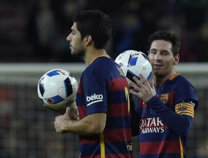 Barcelona’s Uruguayan forward Luis Suarez (left) and Barcelona’s Argentinian forward Lionel Messi (right) leave the pitch after they made it a hat-trick during the Spanish Copa del Rey (King’s Cup) football match FC Barcelona vs Valencia CF at the Camp Nou stadium in Barcelona on Thursday. AFP PHOTO