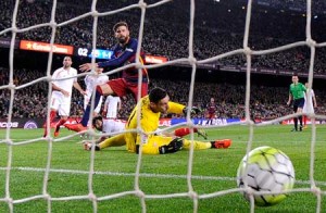 Barcelona’s defender Gerard Pique (second left) scores a goal next to Sevilla’s goalkeeper Sergio Rico during the Spanish league football match FC Barcelona vs Sevilla FC at the Camp Nou stadium in Barcelona on Monday. AFP PHOTO