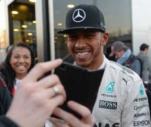 Mercedes AMG Petronas F1 Team’s British driver Lewis Hamilton smiles for fans in the paddock at the Circuit de Catalunya on Thursday in Montmelo on the outskirts of Barcelona on the third test day of the Formula One Grand Prix season. AFP PHOTO 