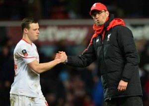 Liverpool’s German manager Jurgen Klopp (right) shakes hands with Liverpool’s Australian defender Brad Smith after the English FA Cup fourth round replay football match between West Ham United and Liverpool at The Boleyn Ground in Upton Park, east London, on Wednesday. AFP PHOTO