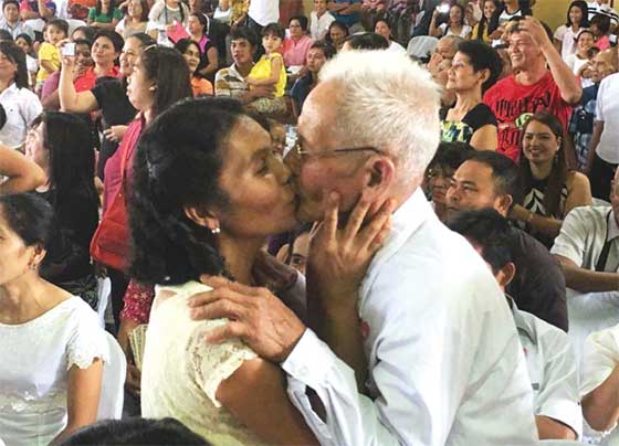 Marcelino Agustin, an 82-year-old widower, kisses his new wife Avelina Masiste, 40, both of Barangay Pulong Yantok, Angat, Bulacan, during a mass wedding on Valentine’s Day sponsored by Mayor Narding de Leon at the Angat Municipal Covered Court. Agustin was the oldest bridegroom who got married on Sunday. A total of 72 couples tied the knot. PHOTO BY FRED SILVERIO