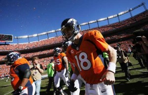 Peyton Manning No.18 of the Denver Broncos runs on to the field prior to the AFC Championship game against the New England Patriots at Sports Authority Field at Mile High on January 19, 2014 in Denver, Colorado. AFP PHOTO 