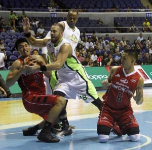 GROUND BATTLE Bradwyn Guinto No.5 and Karl Dehesa No.6 of Mahindra battle Doug Kramer No.18 of Globalsport in a PBA Commissioner Cup game at the Smart Araneta Coliseum in Quezon City on Friday. PHOTO BY MIKE DE JUAN