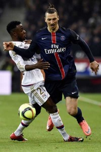 Lyon’s French forward Maxwel Cornet (leaft) vies with Paris Saint-Germain’s Swedish forward Zlatan Ibrahimovic (right) during the French L1 football match Olympique Lyonnais vs Paris Saint-Germain on Monday, at the New Stadium in Decines-Charpieu, centraleastern France. AFP PHOTO