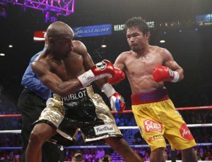 Floyd Mayweather Jr., (left) and Manny Pacquiao of the Philippines fight during their welterweight unification boxing bout at the MGM Grand Garden Arena in Las Vegas, Nevada on May 2, 2015. AFP PHOTO