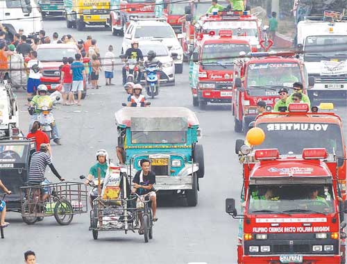 Different fire brigades parade around Metro Manila on Sunday to mark Fire Prevention Month. The biggest number of fires take place in March, the start of the hot season. PHOTO BY CESAR DANCEL