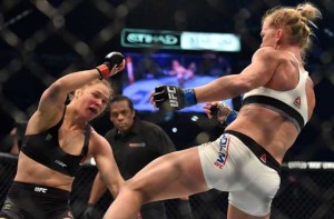 Ronda Rousey of the US (left) goes down after being knocked out by compatriot Holly Holm by a kick to the neck to end the UFC title fight in Melbourne on Sunday. AFP PHOTO 