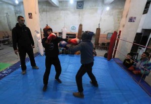 Syrian coach Shaaban Kattan (right) supervises young boxers during a training session at the Shahba boxing club in a rebel-controlled neighborhood of Aleppo’s old city. AFP PHOTO 