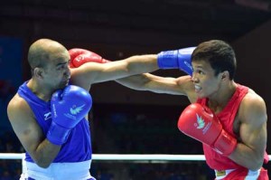 Philippines’ Charly Suarez (right) fights with India’s Akhil Kumar (light) in the men’s boxing light welter 60 kg preliminaries session 6 during the 2014 Asian Games in Incheon on September 26, 2014. The Amateur International Boxing Association proposed recently to allow professional boxers to compete in this year’s Rio Olympics. AFP FILE PHOTO