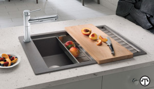 A cleverly designed kitchen sink that includes a drainer and cutting board can help you create great meals even if you don't have a lot of space.