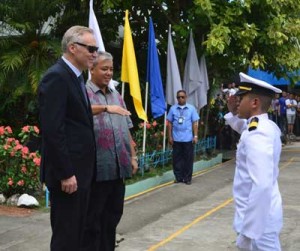 A marine student salutes Ambassador Erik Førner and Dr. Ronald Raymond Lacson Sebastian at the 67th foundation celebration of John B. Lacson College