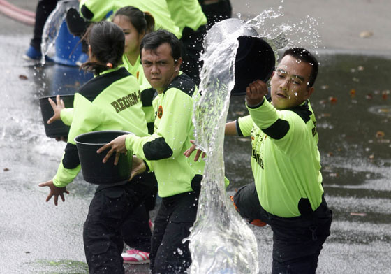Firefighters hone their skills on water bucket relay during the National Fire Olympics held to mark Fire Prevention Month. Firefighters from various regions participated in the event held at the Quezon City Memorial Circle. PHOTO BY MIKE DE JUAN 