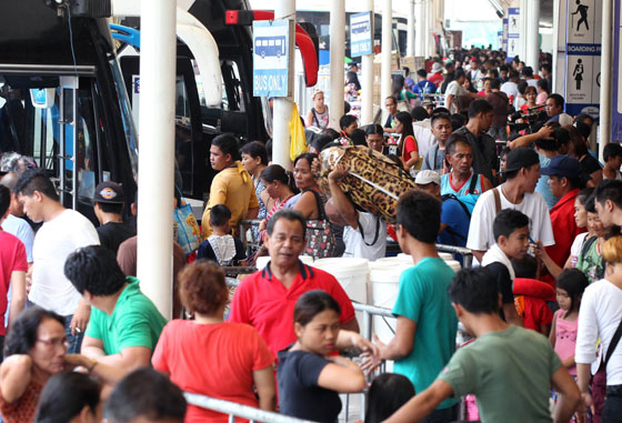 Passengers fill a bus terminal in Cubao, Quezon City on Saturday as some Filipinos start their annual trek to the provinces for their Holy Week break. Photo By Mike De Juan 