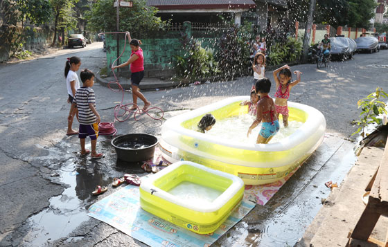 No trip to the beach? no problem. children in a neighborhood in malabon keep cool on an inflatable pool where they can splash from sunup to sundown without fear of drowning. Photo By RENE H. DILAN 
