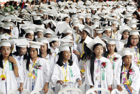 Happy and giddy, students of the Lupang Pangako Elementary School prepare to march during their graduation ceremony in Quezon City. PHOTO BY MIKE DE JUAN
