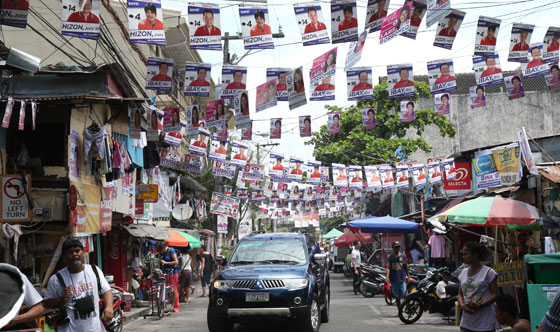  A street in Intramuros, Manila, is made festive by the dozens of campaign materials strung or illegally pasted on walls. The area is near the national headquarters of the Commission on Elections. PHOTO BY RENE H. DILAN 