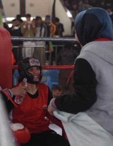 Female Afghan boxer Sadaf Rahimi (left), 19, takes a break during a selection bout at an inter-provincial boxing competition at Ghazi Stadium in Kabul. AFP PHOTO