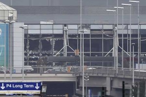 picture taken on Tuesday in Zaventem, shows the damaged facade of Brussels airport after at least 13 people were killed and A 35 injured as twin blasts rocked the main terminal of Brussels airport. AFP PHOTO